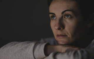 Woman looking tired and burnt out and helping to drive the message of Checking Your Writer's Battery so that you don't burn out
