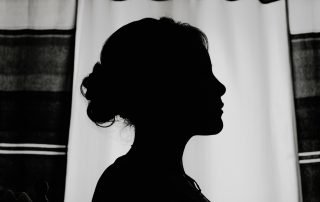 silhouette of a woman's profile with her hair pulled up in a bun to help demonstrate the theme of Your Character Needs a Body